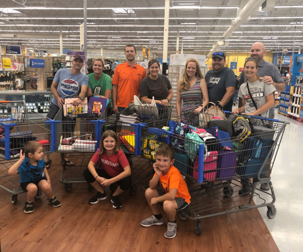 Mariner Wealth Advisors associates giving back by taking students back to school shopping.